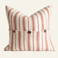 Square terracotta and natural striped French linen cushion cover with coconut button detailing.