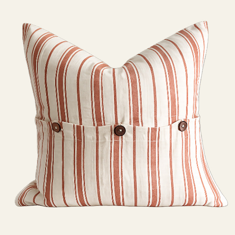 Square terracotta and natural striped French linen cushion cover with coconut button detailing.
