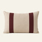 Rectangular natural linen lumbar cushion cover with two deep burgundy vertical panels.

