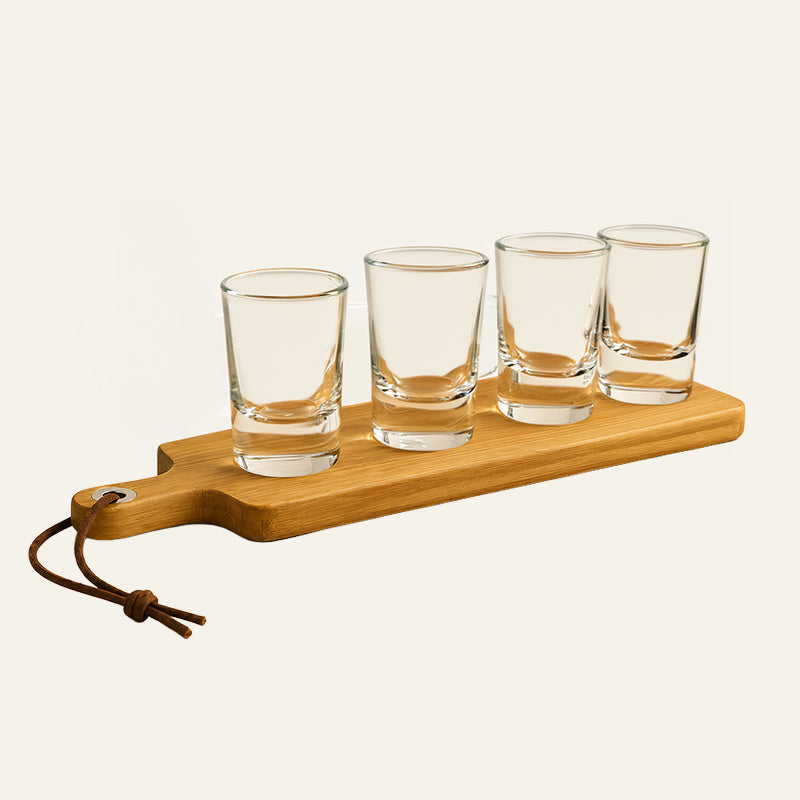 Wooden paddle shot glass serving set with four empty clear glasses and hanging strap