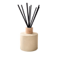 Diffuser with black sticks on a beige base 