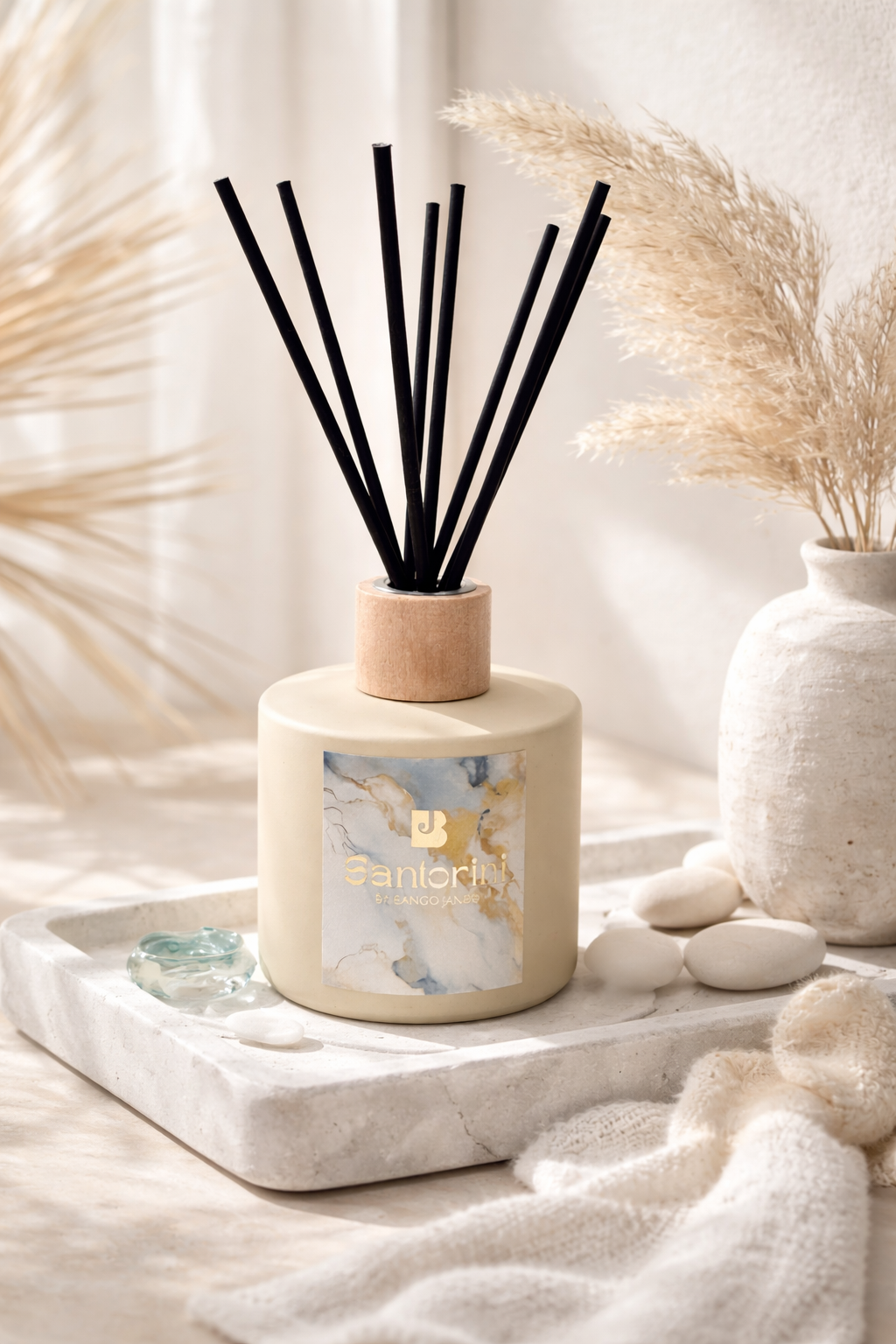 Diffuser with black sticks on a white surface with decorative elements