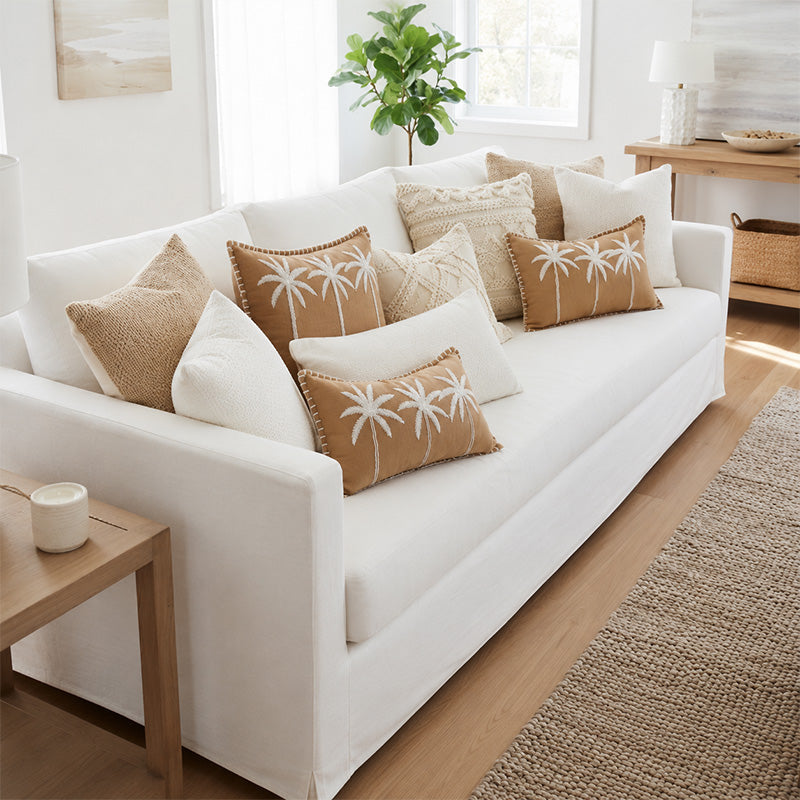 white sofa with neutral and tan cushions