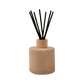 Diffuser with black reeds in a tan container 