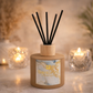 Santorini diffuser with black reeds on a blurred background with candles