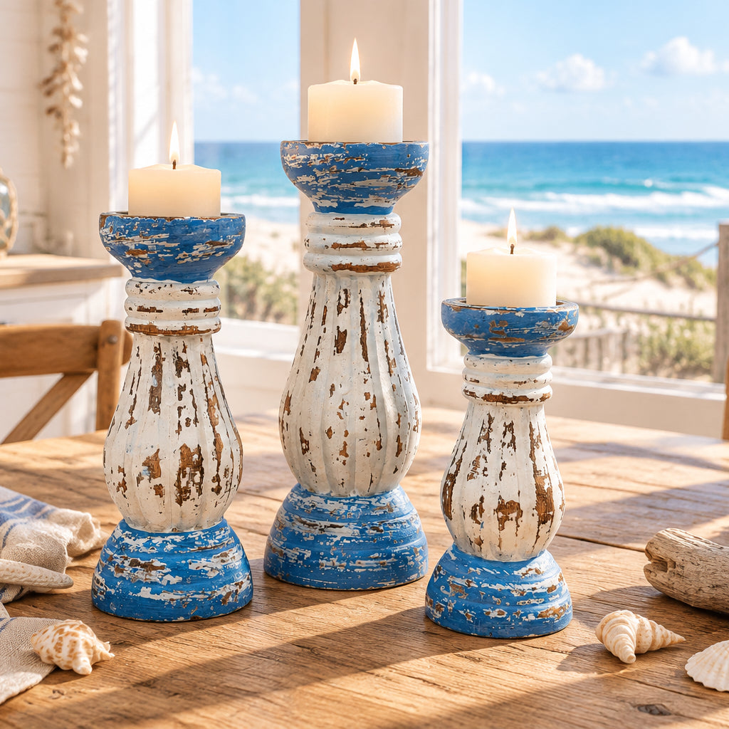Three distressed wooden candlesticks in a vintage shaker style, featuring a blue and white paint scheme with peeling brown paint showing through.