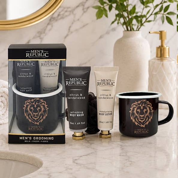 Men's Republic grooming products on a marble countertop with a mirror and plant in the background.