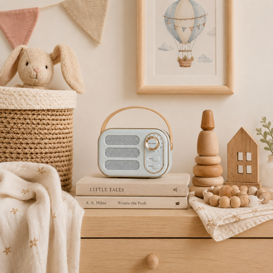 Nursery setup with toys, books, and a vintage style speaker on a wooden surface.