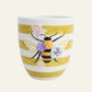 Ceramic planter with yellow and white stripes, raised bee design and pastel flower details.