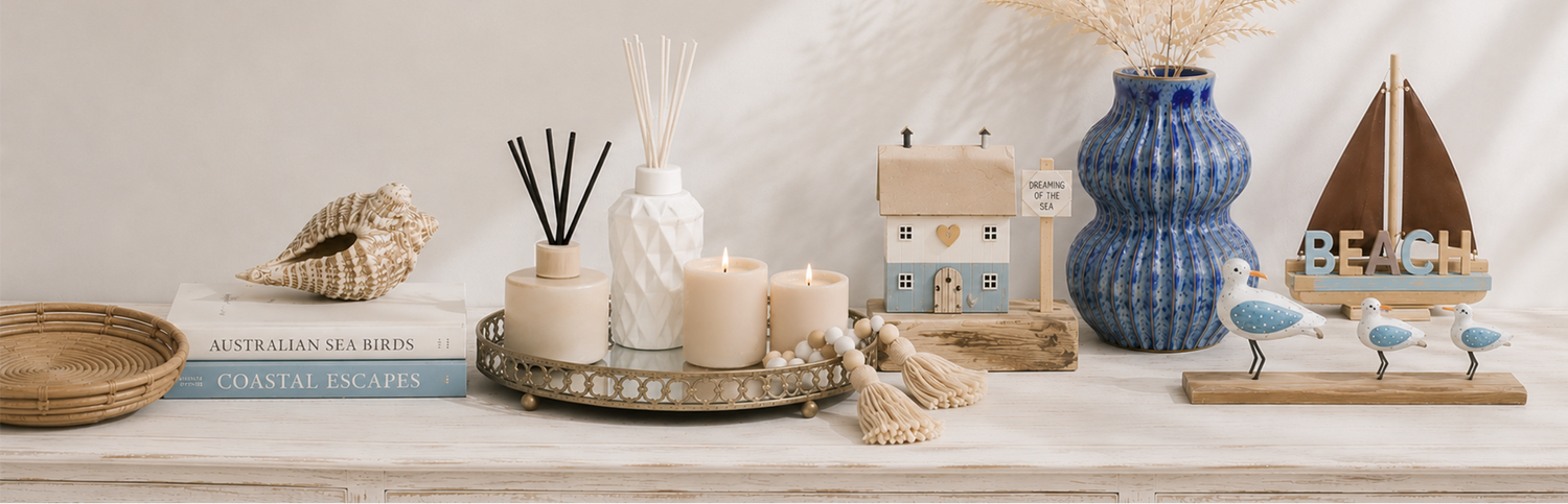 Decorative items on a shelf including candles, a diffuser, and decorative objects.