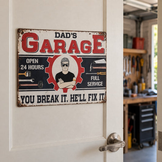 Dad’s Garage metal sign displayed on a cream internal door opening into a garage workshop with tools and a workbench.