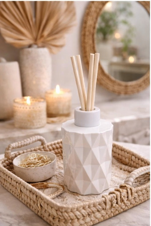 Decorative diffuser with candles and a mirror in the background