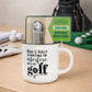 Golf-themed mug with text and multi-tool on a wooden surface with golf accessories in the background.