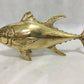 Brass fish sculpture on a white background