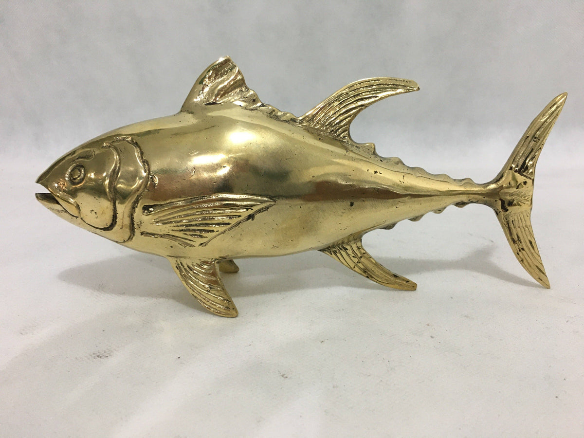 Brass fish sculpture on a white background