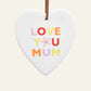 Heart-shaped ceramic ornament with 'Love You Mum' text on a plain background