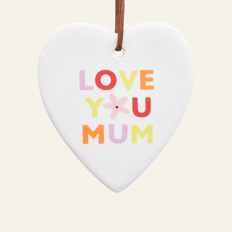 Heart-shaped ceramic ornament with 'Love You Mum' text on a plain background