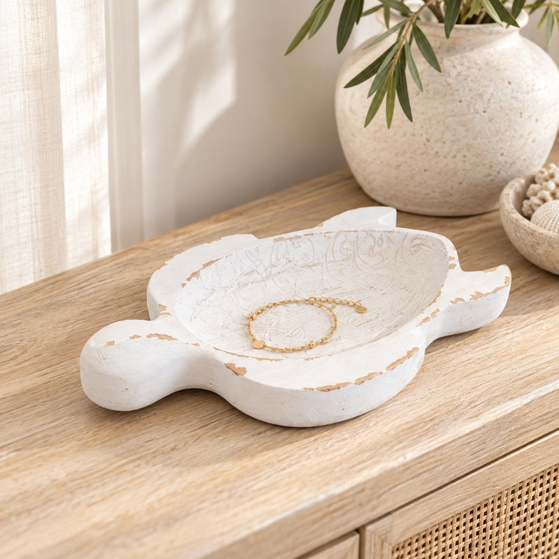 Top view of a rustic white turtle-shaped wooden bowl with a shallow centre and carved detailing.
