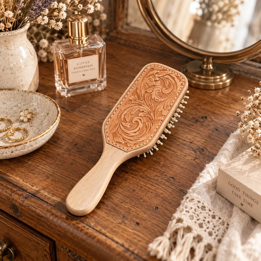 tooled leather tan hairbrush sitting on a country styled 
dressing table
