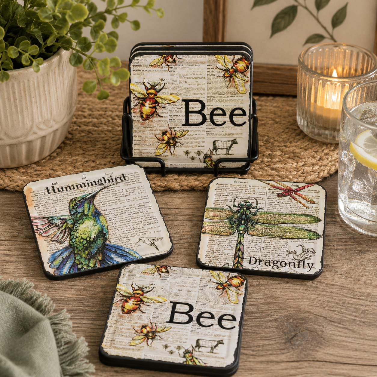 Set of four coasters with insect illustrations on a wooden surface.